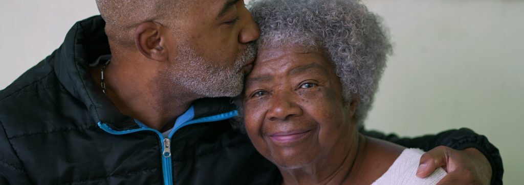 a man with his arm around an aging woman